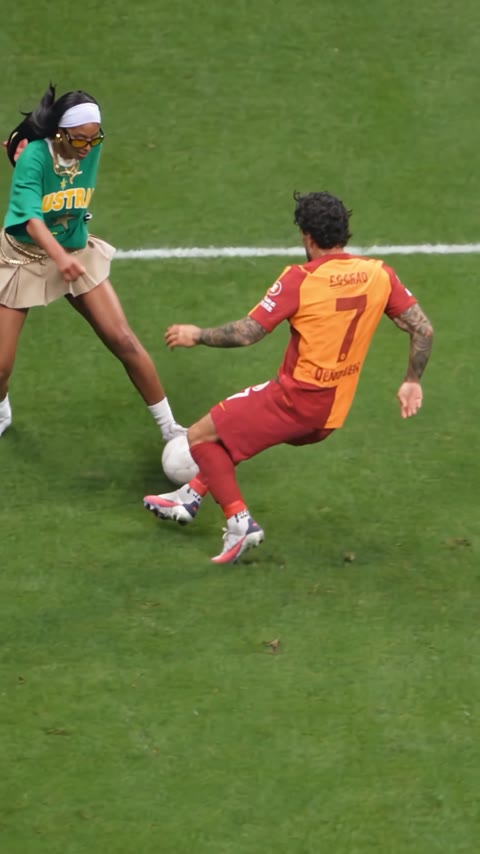 Sample 3: a young woman in a green T-shirt does the fake rabona past the defender
